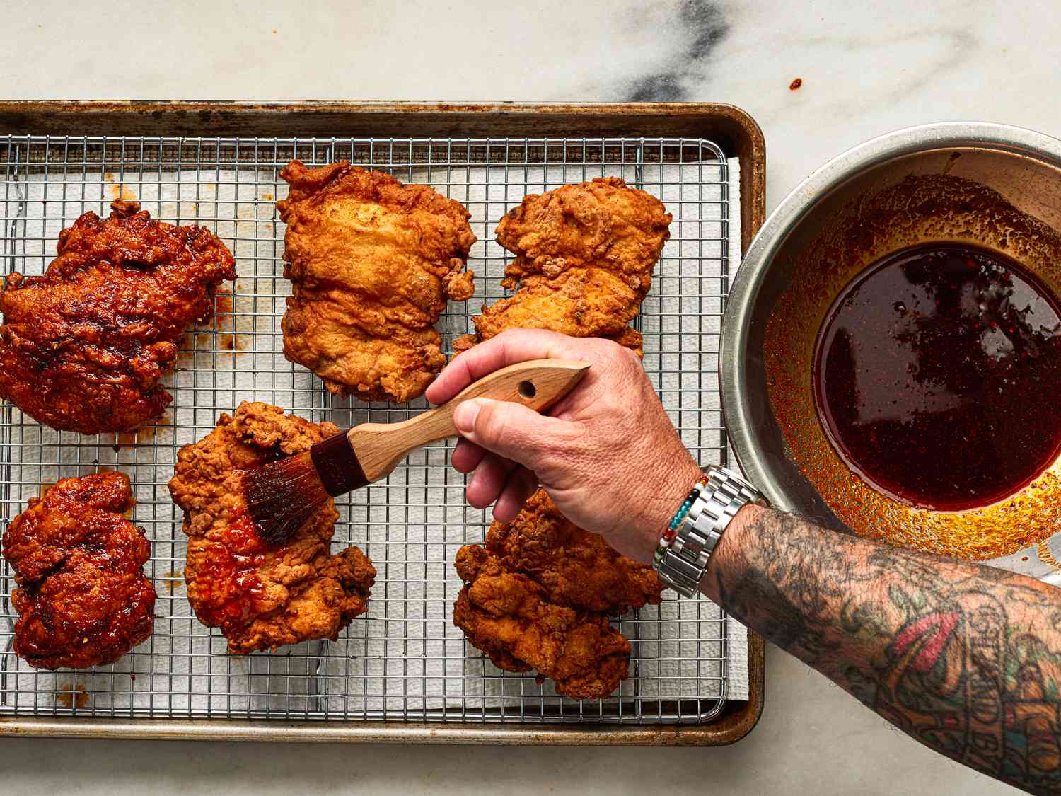 Overhead view of brushing chicken with sauce 