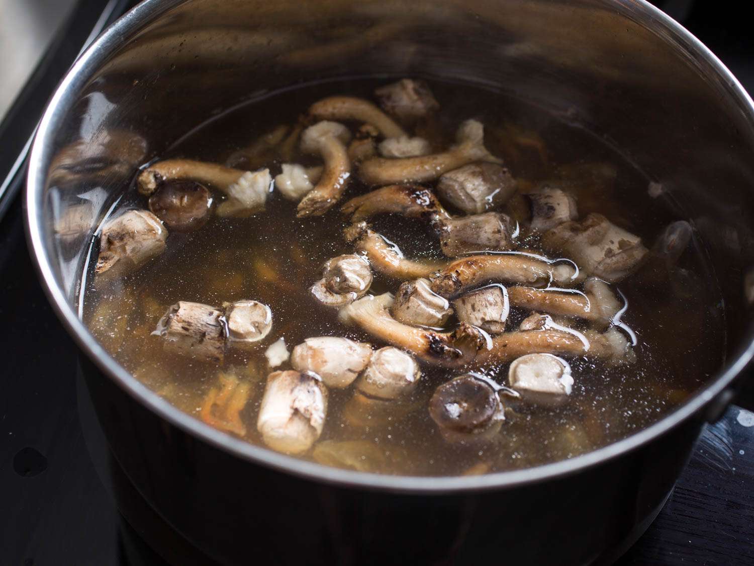 Infusing chicken stock with mushroom trimmings and shrimp shells.
