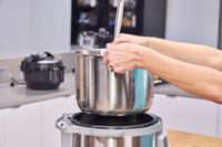 A person lifts the pot out of the Instant Pot Duo Plus 8 Quart Multi-Use Pressure Cooker