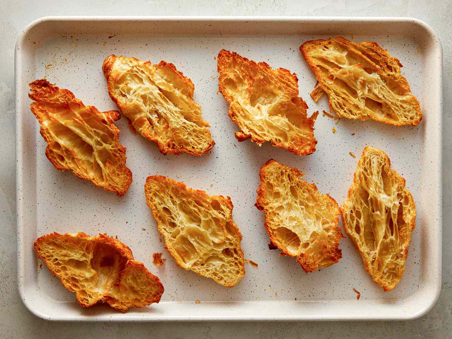 Baked flaky pastry pieces on a tray