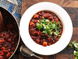 Overhead view of a bowl of vegan sweet potato and 2-bean chili with hominy.