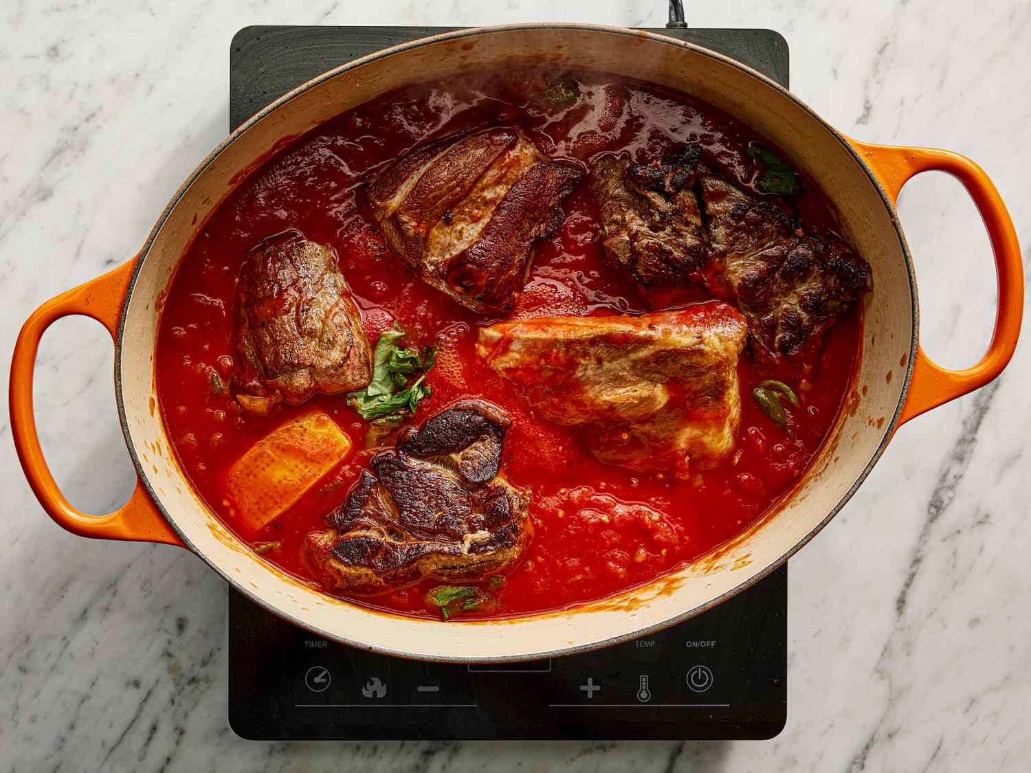 Overhead view of all ingredients added back to dutch oven
