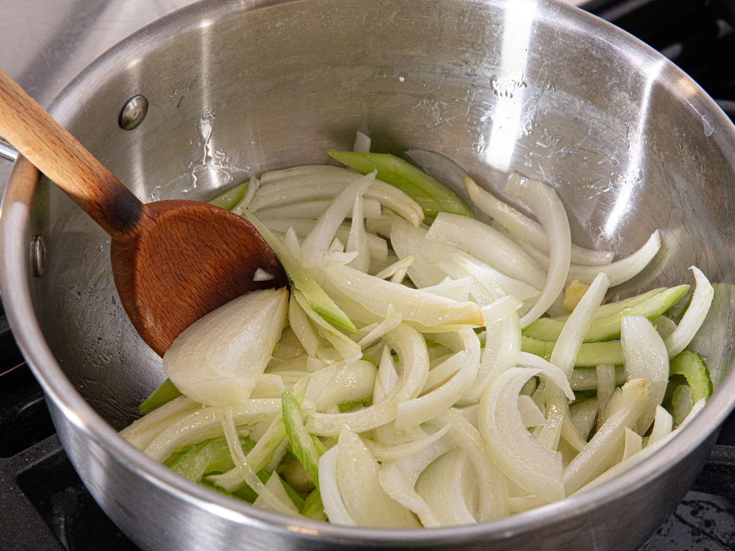 Overhead ove cooking onions and celery