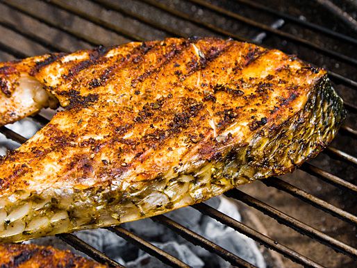 A grilled fish steak on a grill.