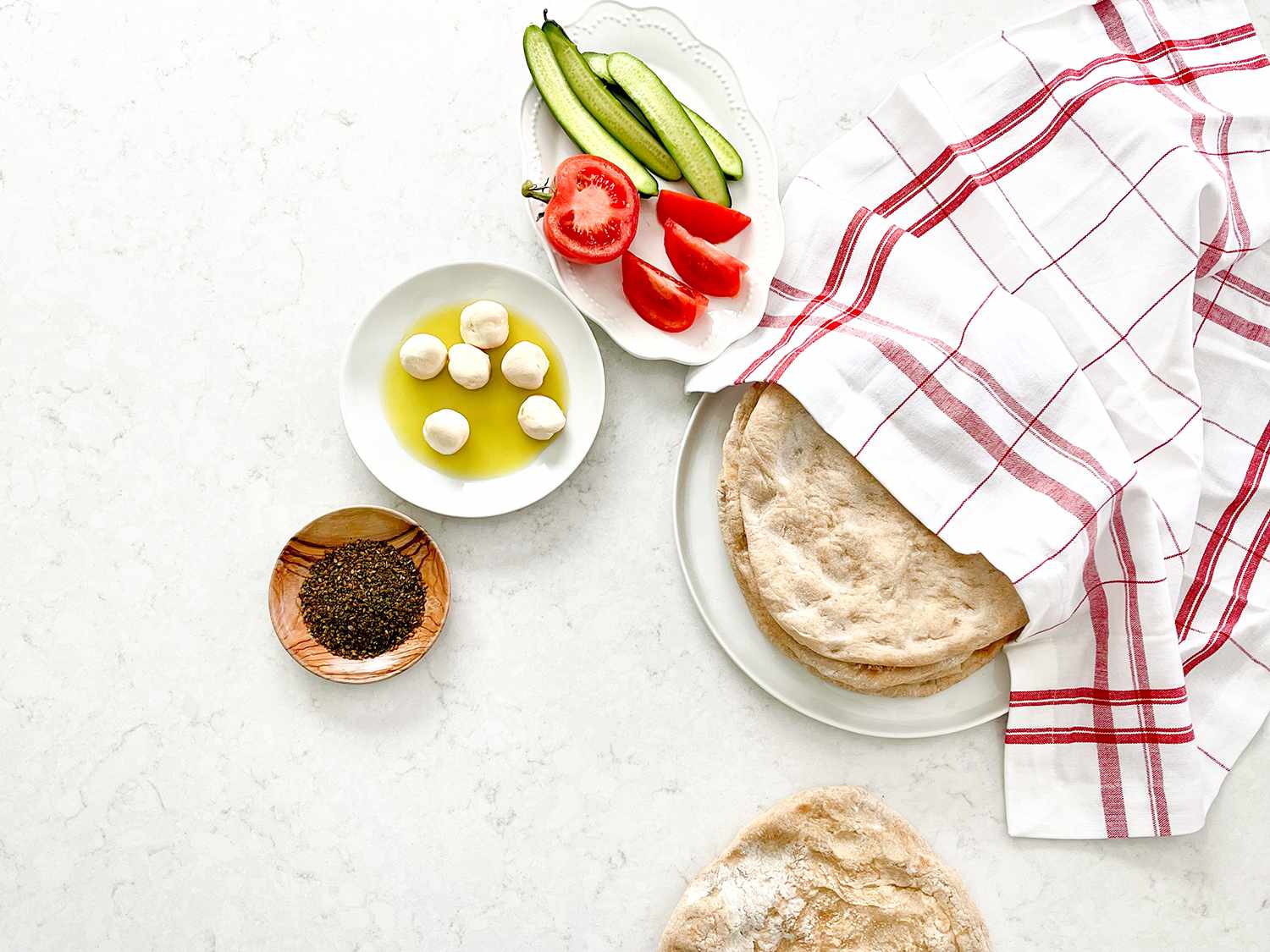 Taboon breads and cheeses, veggies, and spices.