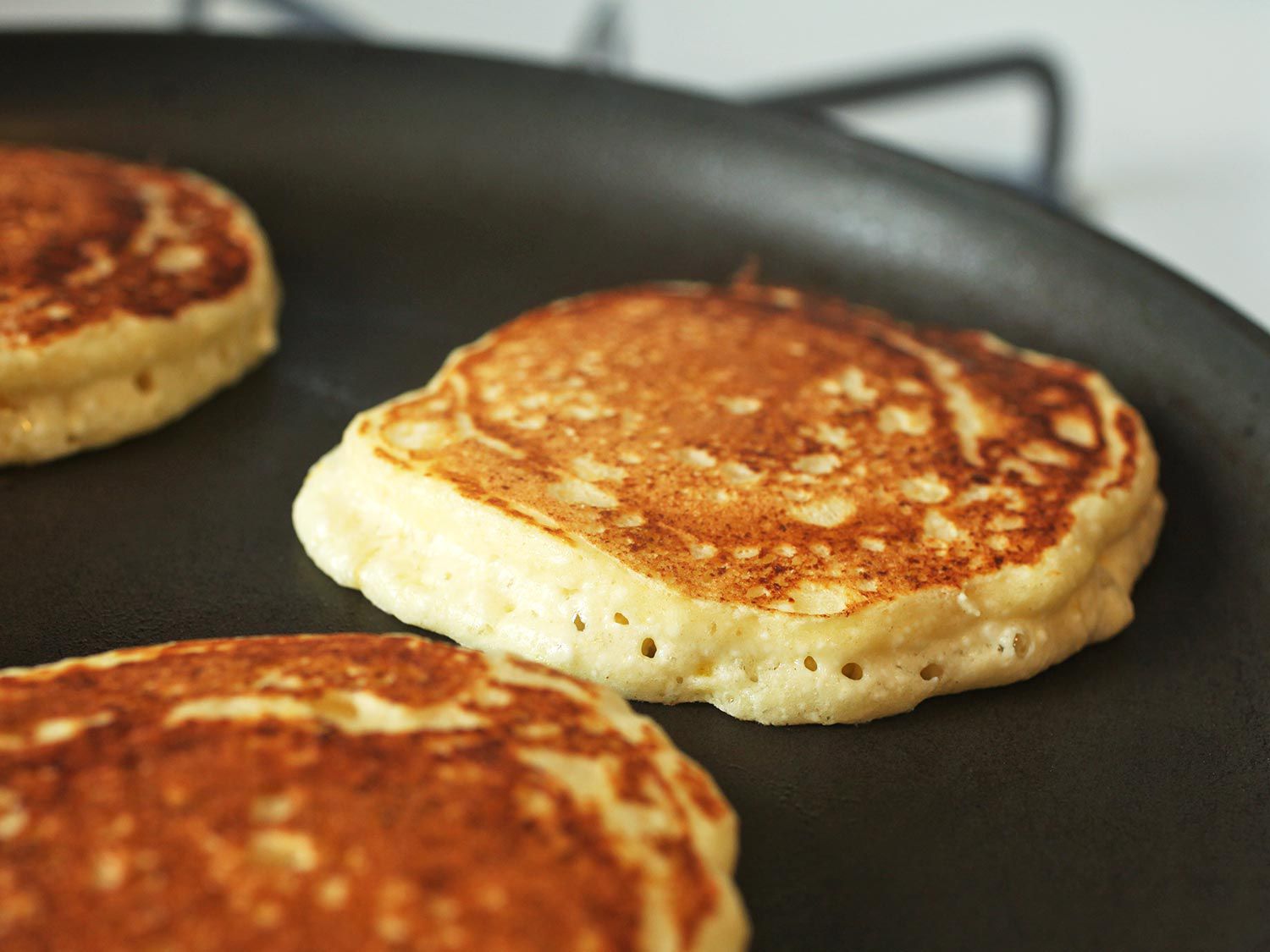 Golden brown buttermilk pancakes in a skillet
