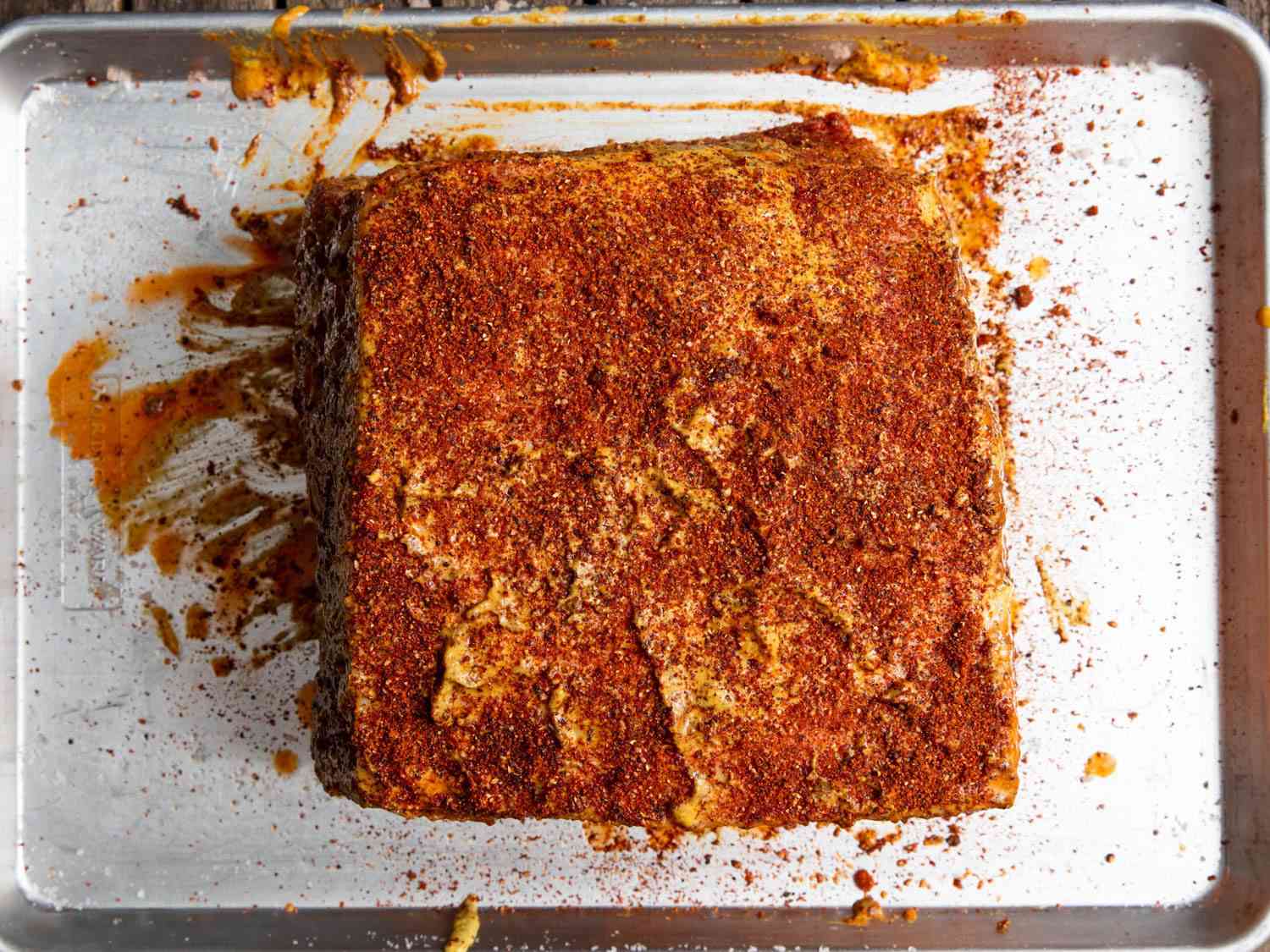 A pork shoulder with the dry rub applied