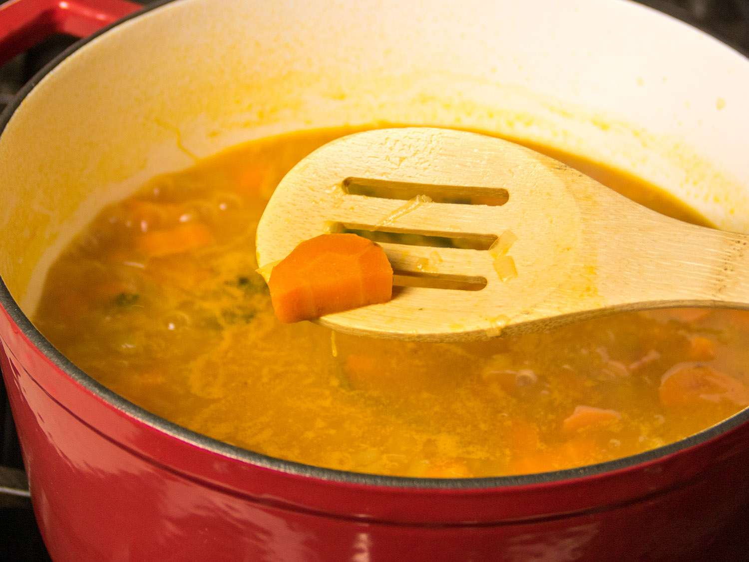 Carrot soup cooking in a Dutch oven.