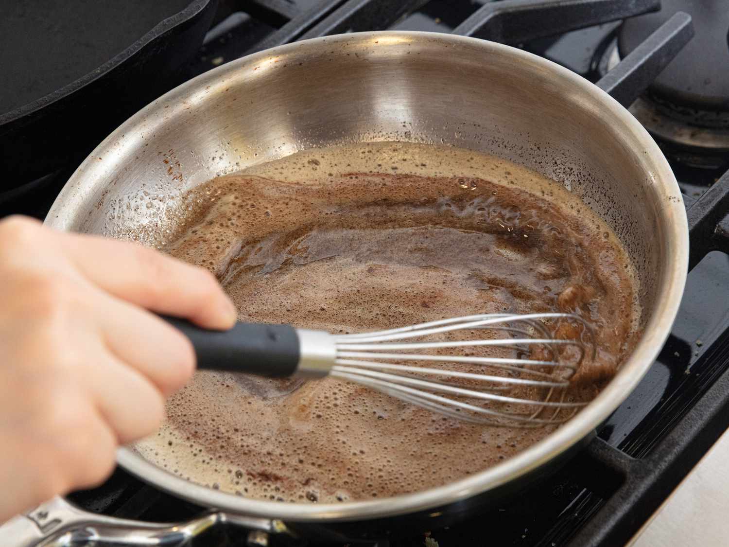 whisking melted butter and cinnamon on saucepan