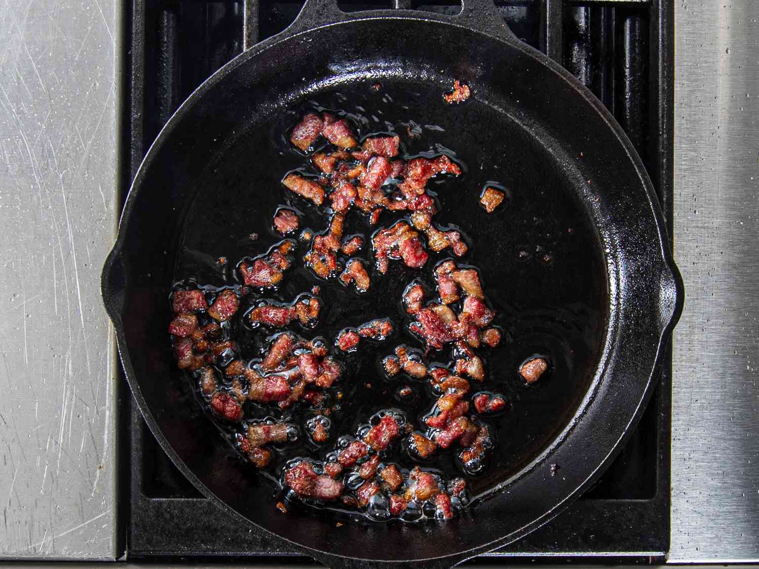 Corned beef fat crisped in cast iron skillet on stove