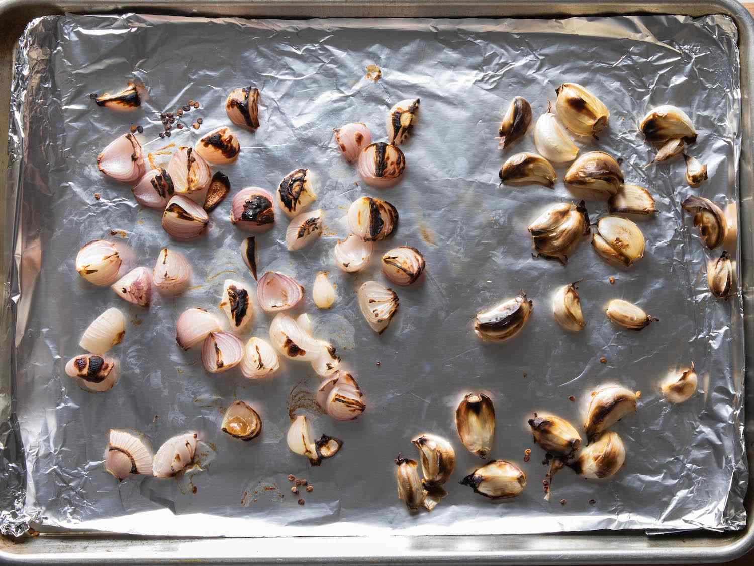 Shallots and unpeeled garlic cloves on a foil-lined baking sheet, broiled until charred in spots.