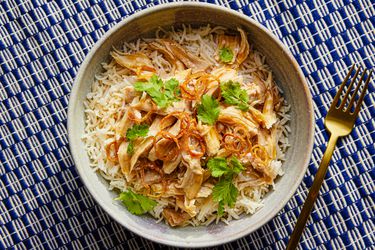 Overhead view of taiwanese turkey and rice on a blue and white stripped background