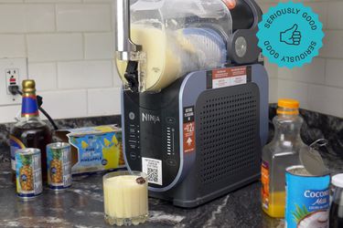 the ninja slushi making painkiller frozen cocktail with ingredients on the side