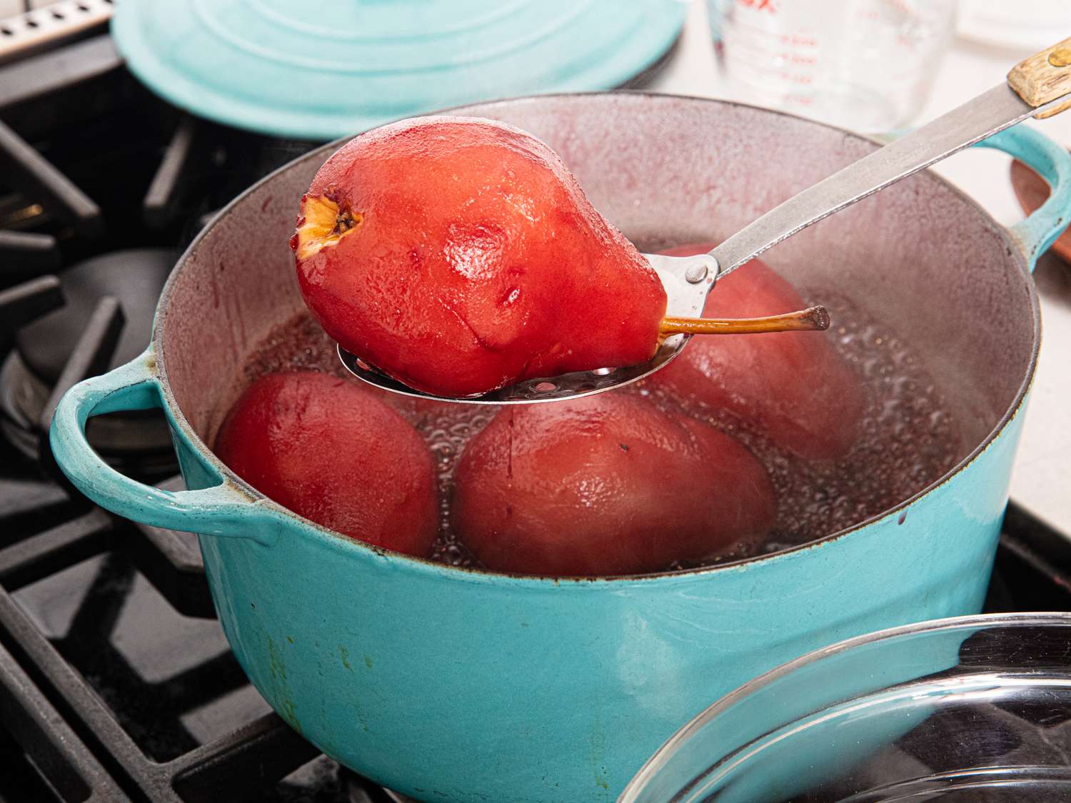 Overhead view of lifting pear out of pot