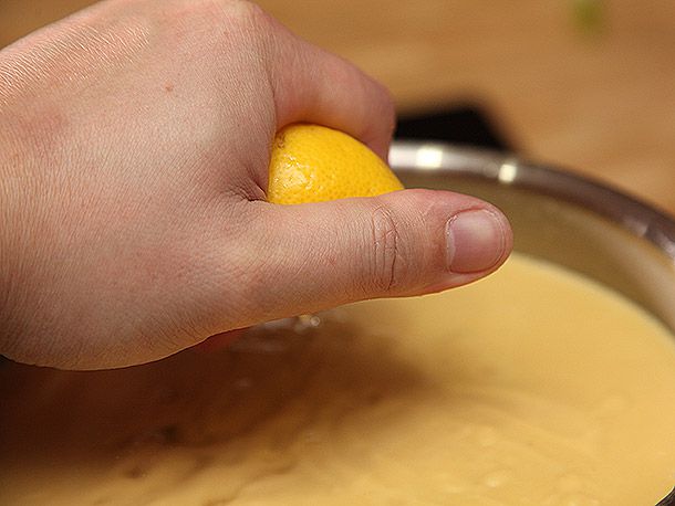 The author squeezes a lemon over the puréed soup.