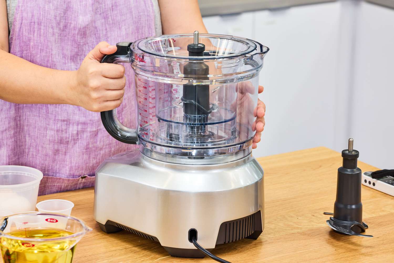 A person attaches the bowl to the Breville 16-Cup Sous Chef Peel & Dice Food Processor