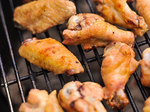 Grilling chicken wings to golden brown.