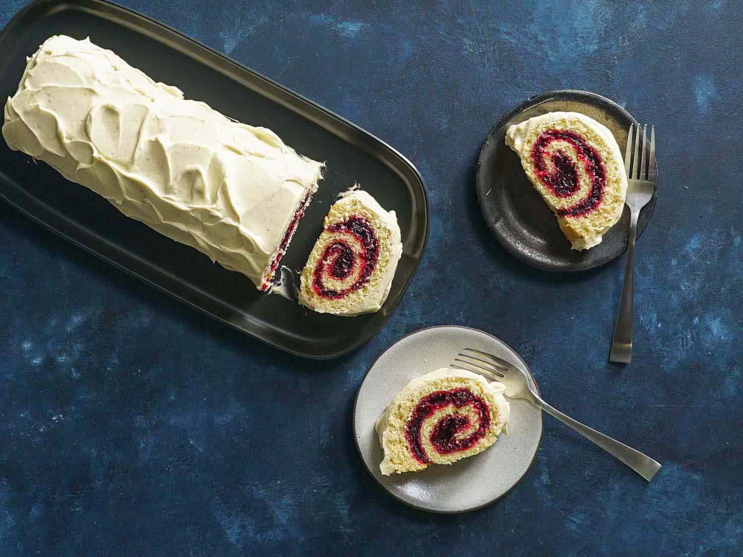 Overhead shot of plated slices of frosted jelly roll cake
