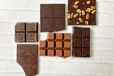 A collection of unwrapped chocolate bars on a white background