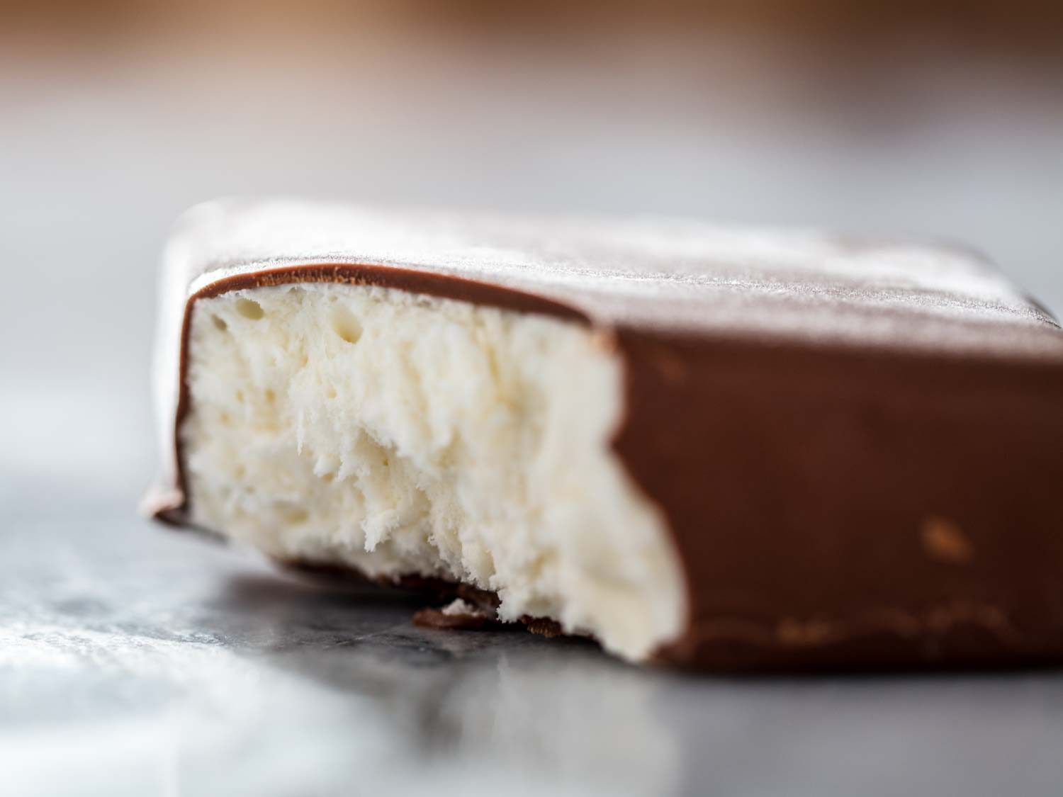 Closeup of a homemade Klondike Bar with a bite taken out of it.