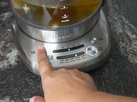 a person setting the breville smart tea infuser kettle