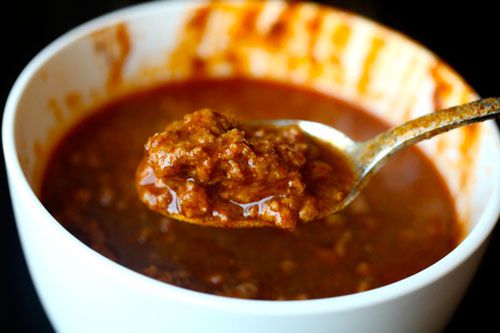 A spoonful of the chili test is held up for the camera.