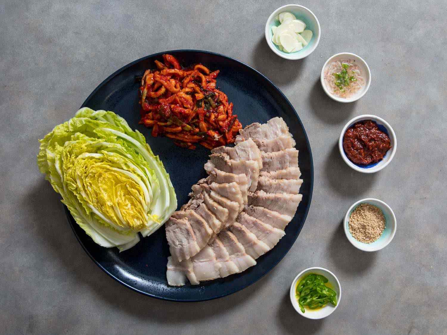 A Korean bossam feast with all the condiments, sauces, and flavorings