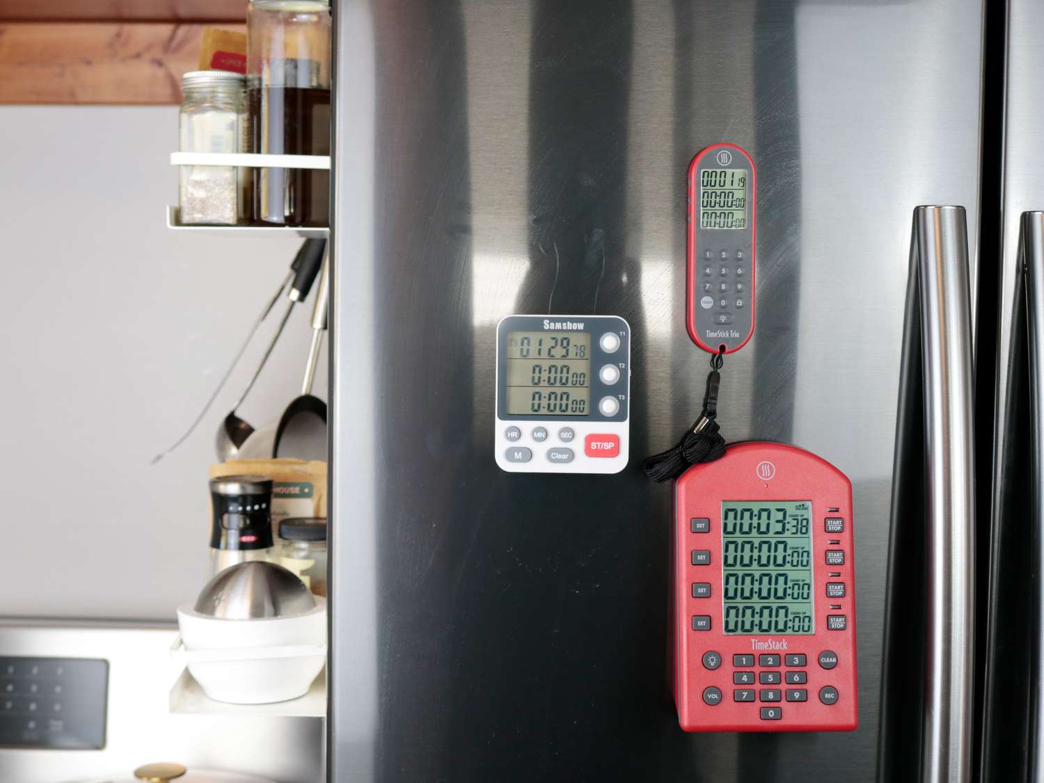 three kitchen timers on a fridge