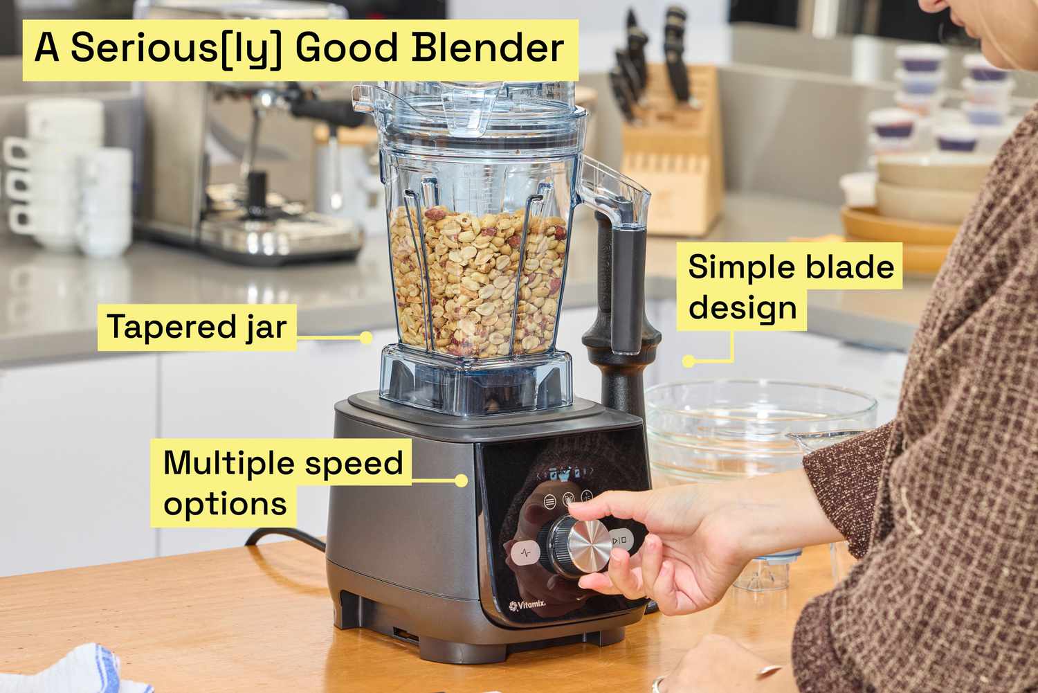 A person blending peanuts in the Vitamix Ascent X5 blender.