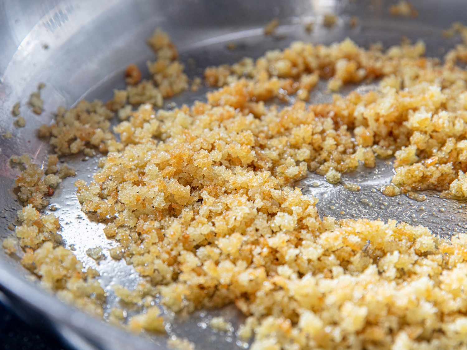 Breadcrumbs being toasted in a skillet