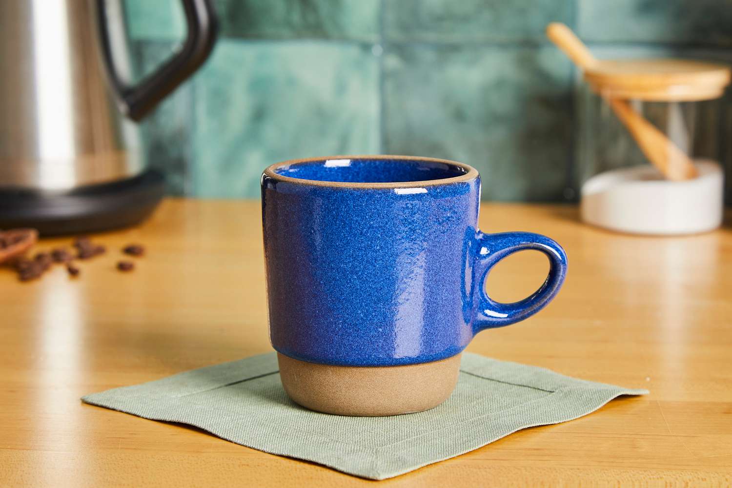 A blue Health ceramic mug on a kitchen countertop.