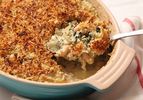 Serving up a portion of Swiss chard, fennel, and white bean gratin
