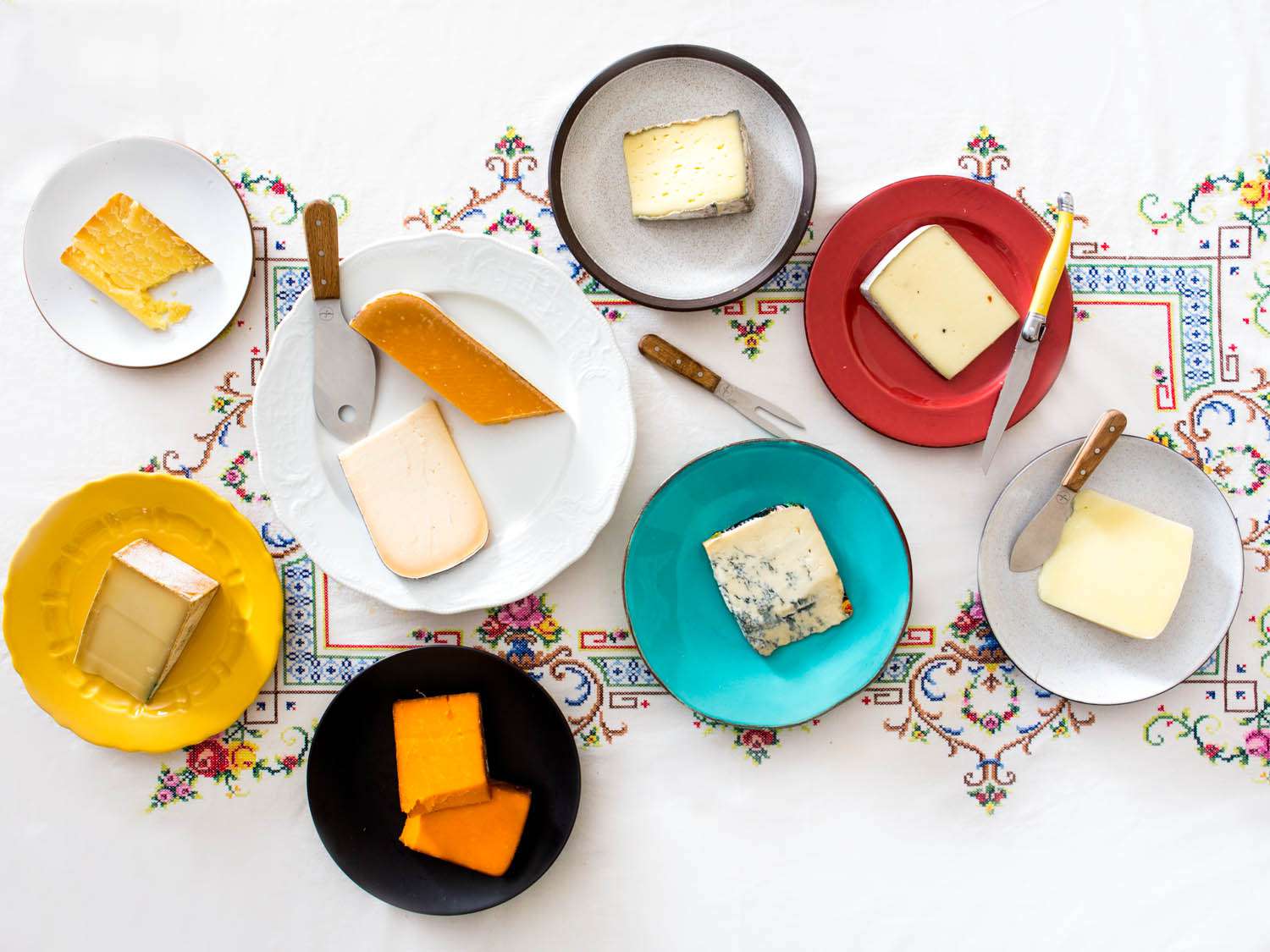 A cheese spread laid out across a long table.