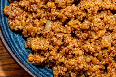 Overhead view of freekeh on a blue plate