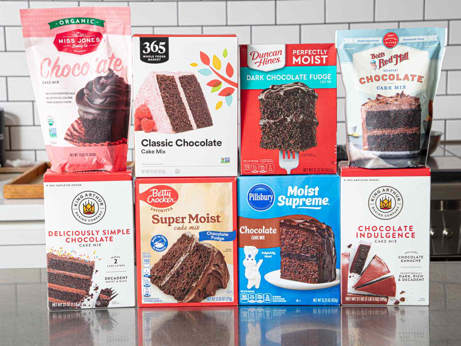 A display of boxed chocolate cake mixes from various brands arranged on a countertop