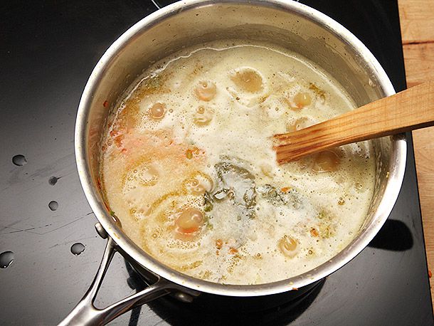 Lentils and stock are added to the pot and brought to a simmer.