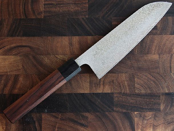 santoku knife on a wooden cutting board