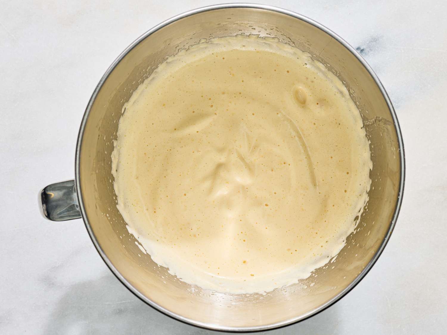 A bowl with a whipped batter or cream mixture likely a preparation step in a recipe