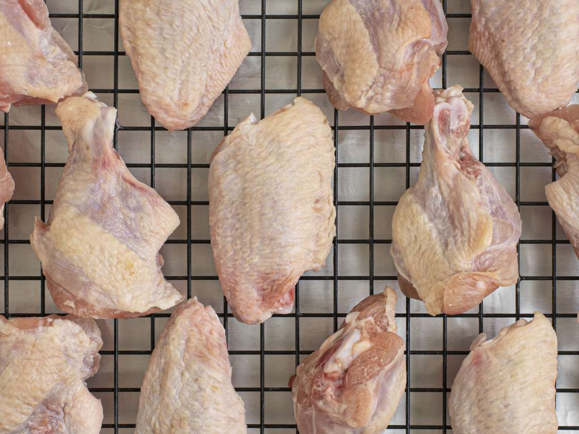 A close up of the skin of chicken wings after they've been dried in the fridge overnight.