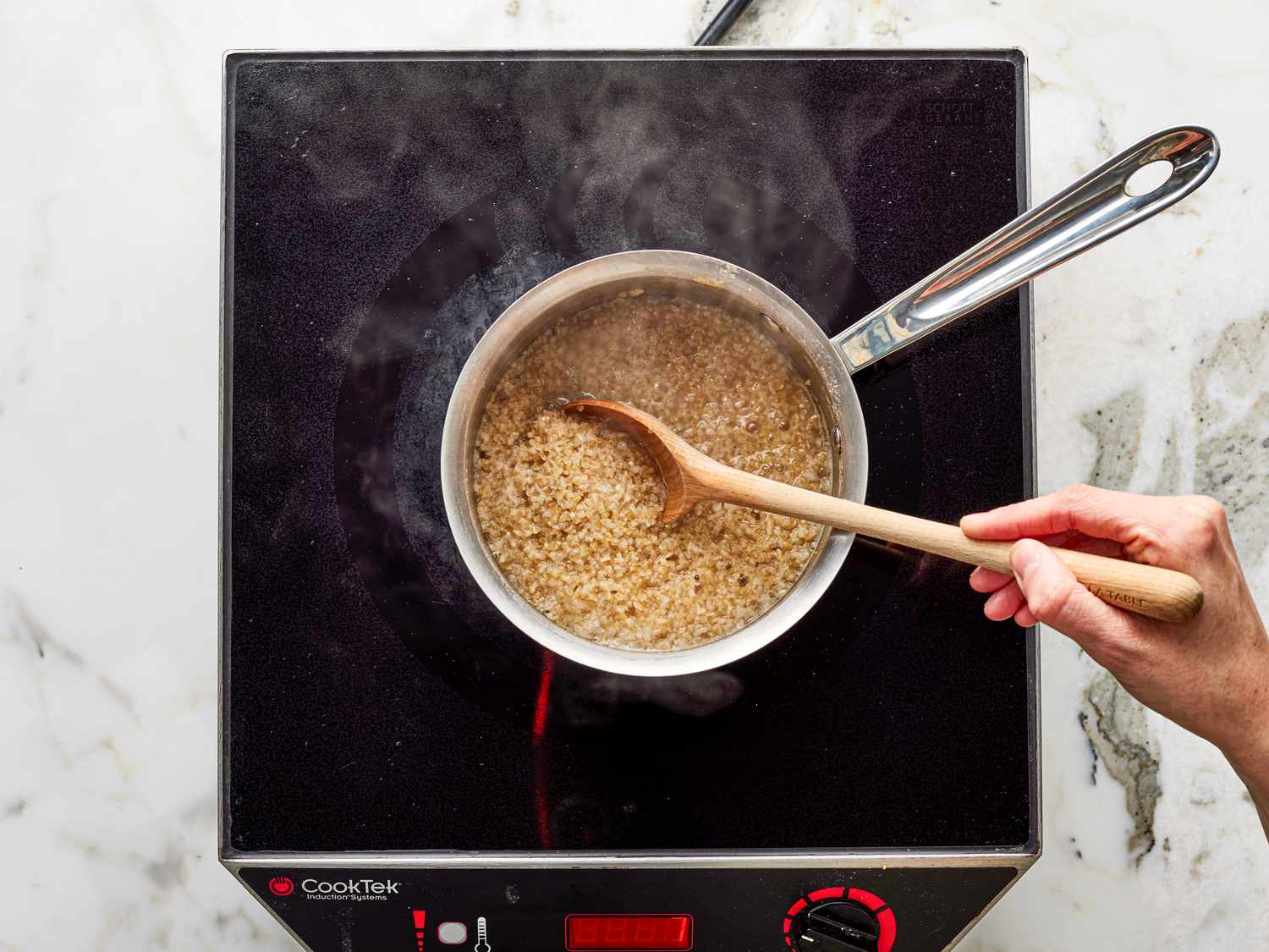Overhead view of bulgar wheat being brought to a boil