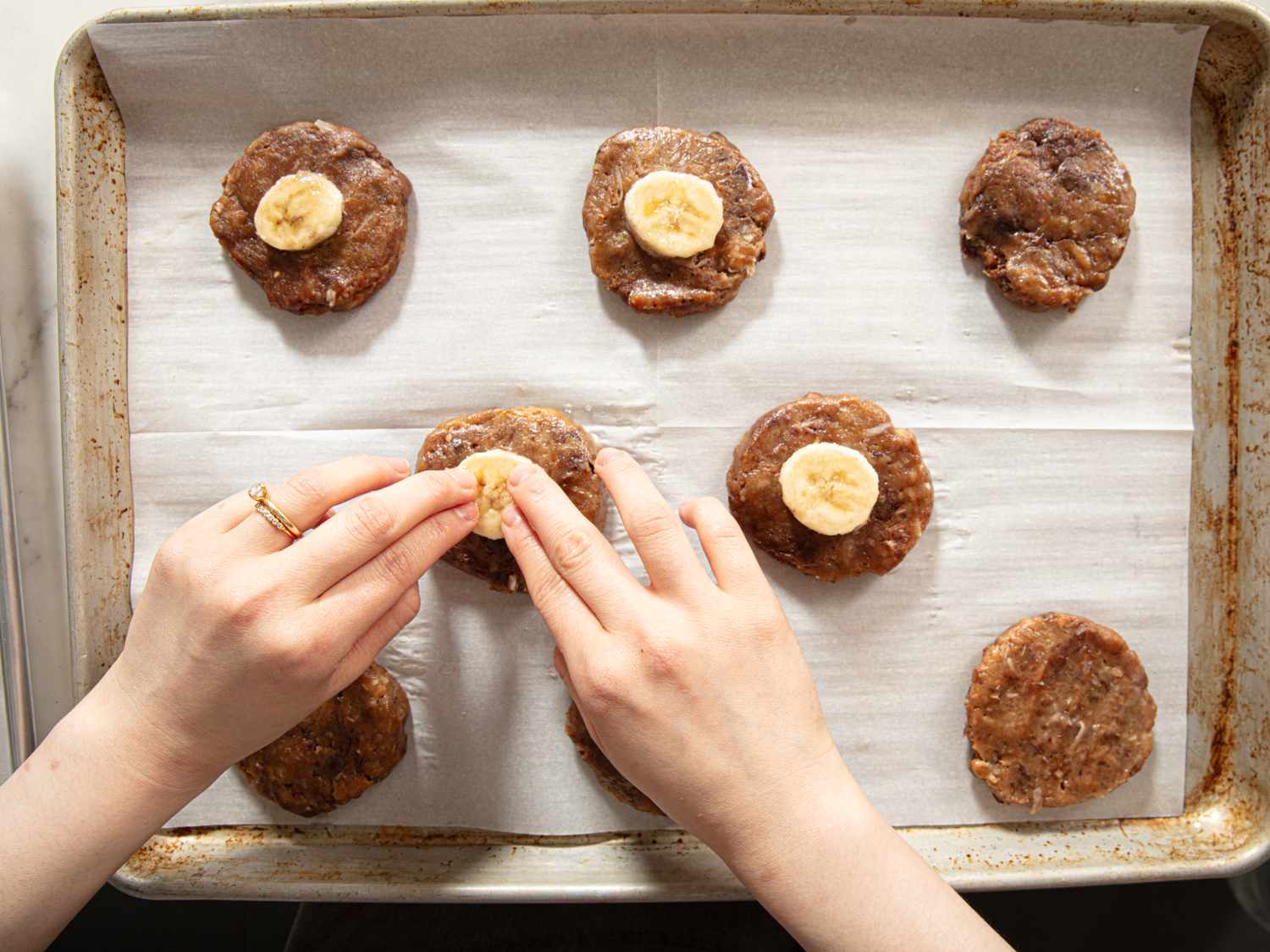 Overhead view of adding banana to cookies