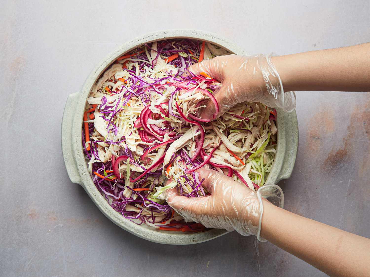 Overhead view of mixing salad together