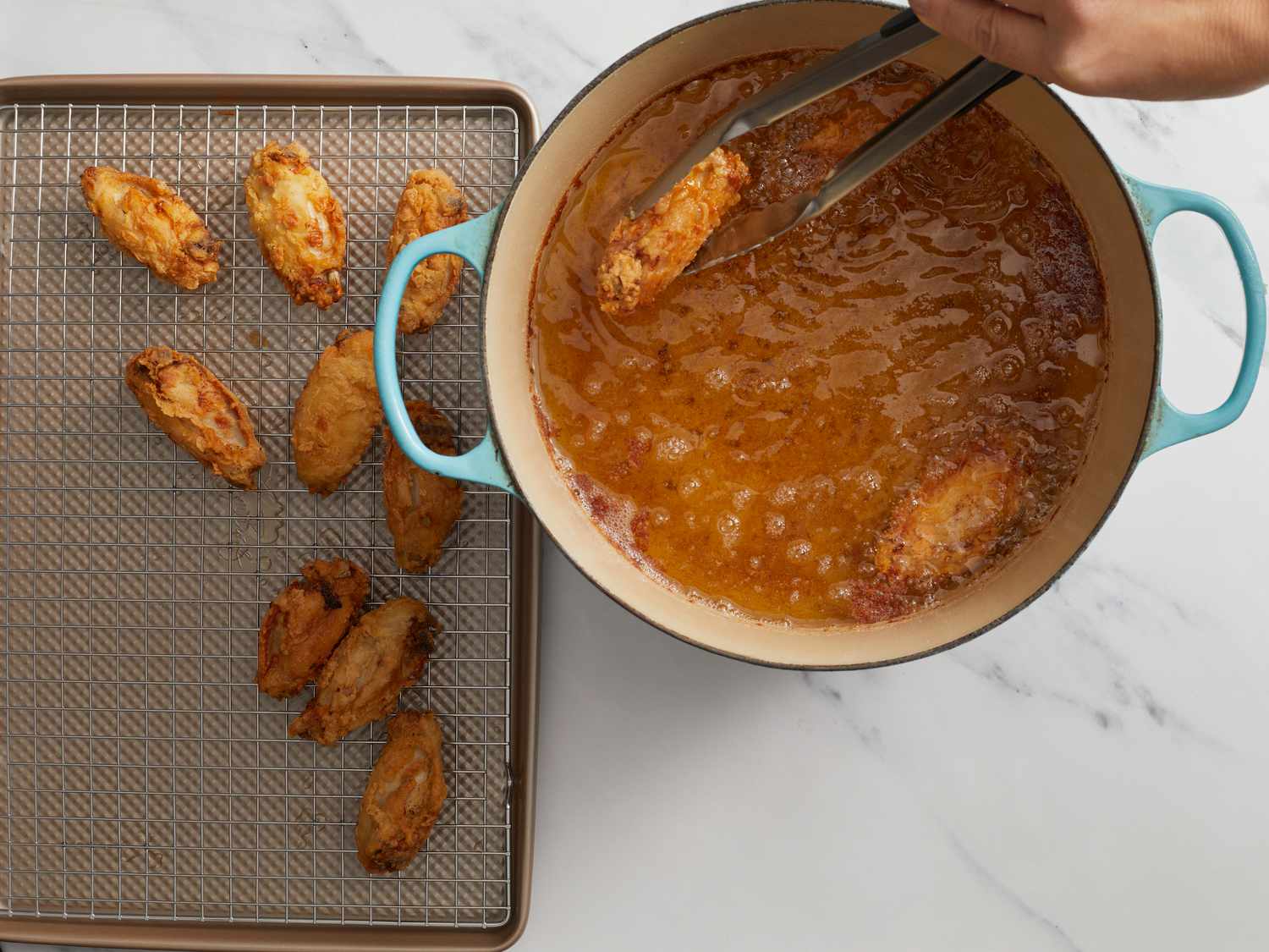 Frying wings in hot oil in dutch oven 