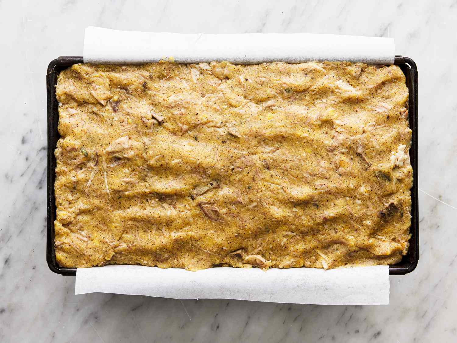 Scrapple mixture in a parchment lined loaf pan