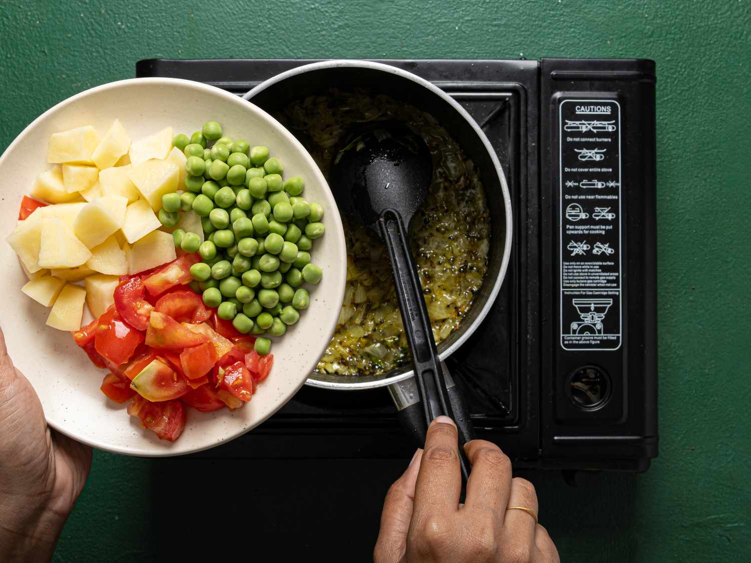 Overhead view of adding vegetables