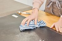 A person wipes down the Sky Solutions Sky Mat 0.75-Inch Comfort Anti-Fatigue Mat