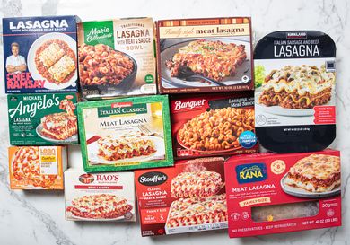Various frozen lasagna packages arranged on a marble surface highlighting different brands and styles of lasagna