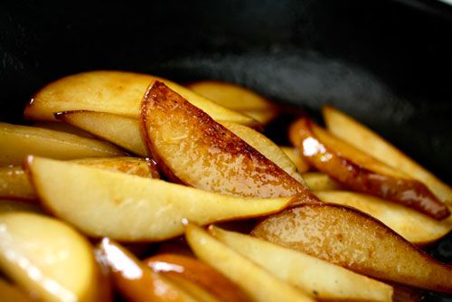 Close up of pear slices caramelizing in the skillet. 