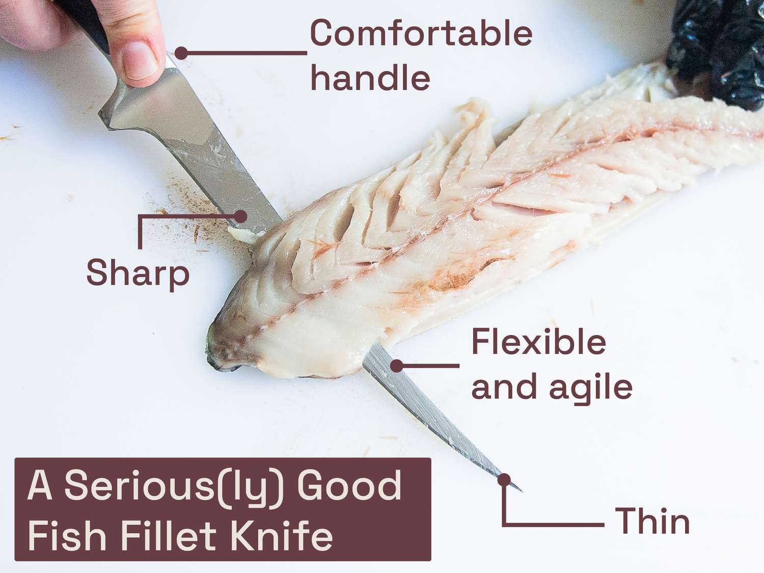 a person using a fish fillet knife to remove the skin from a piece of mackerel