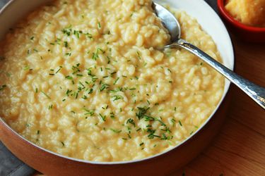 Bowl of creamy vegan risotto with serving spoon